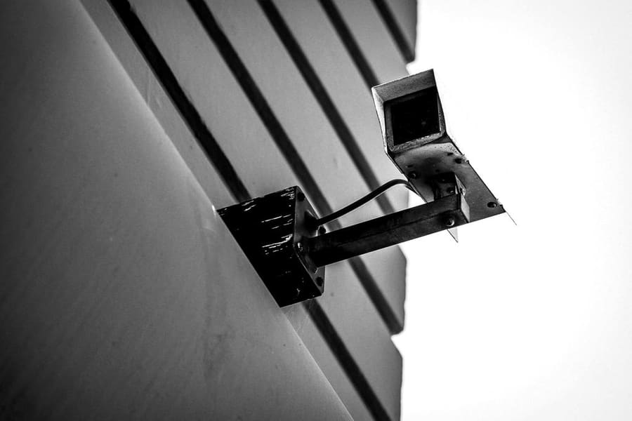 CCTV camera on an arm fixed to a building facade