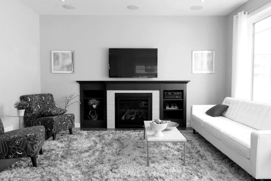 Living room with a television mounted on the wall above a fireplace